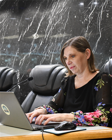 woman at desk typing