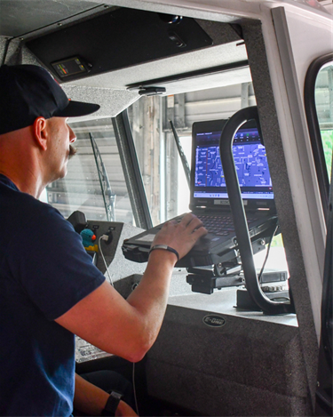 man in truck at laptop