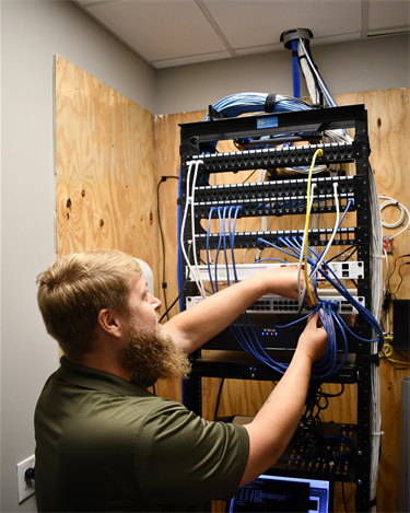 man organizing wires 