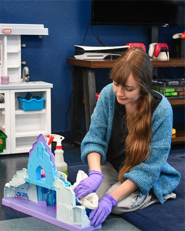 girl cleaning toy