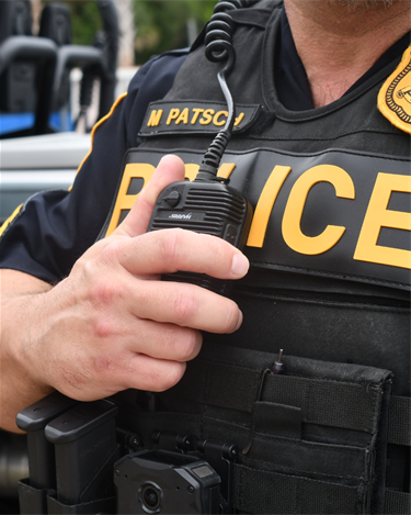 officer holding radio on chest