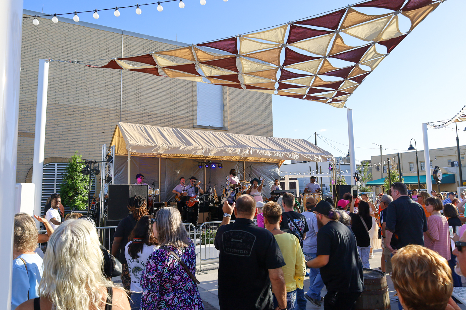 concert with crowd under canopy on public square