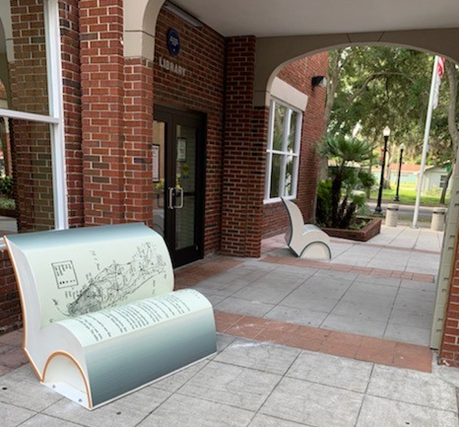 Brick building with benches shaped as books