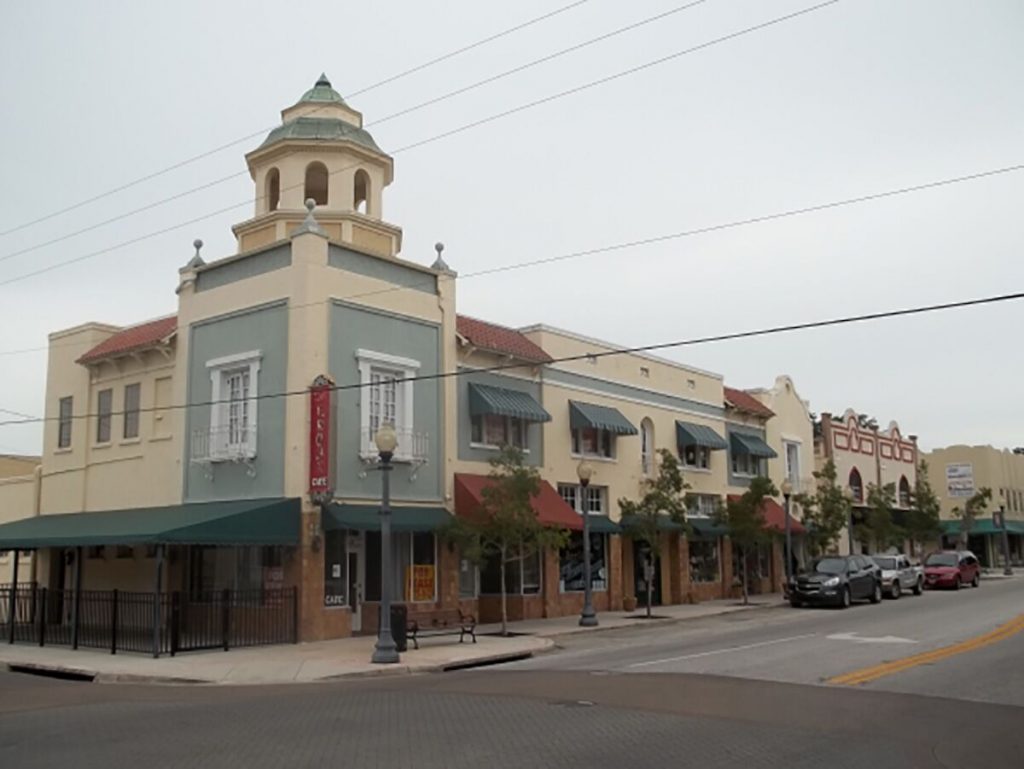 A street corner in New Port Richey. A building with a cupola is prominent