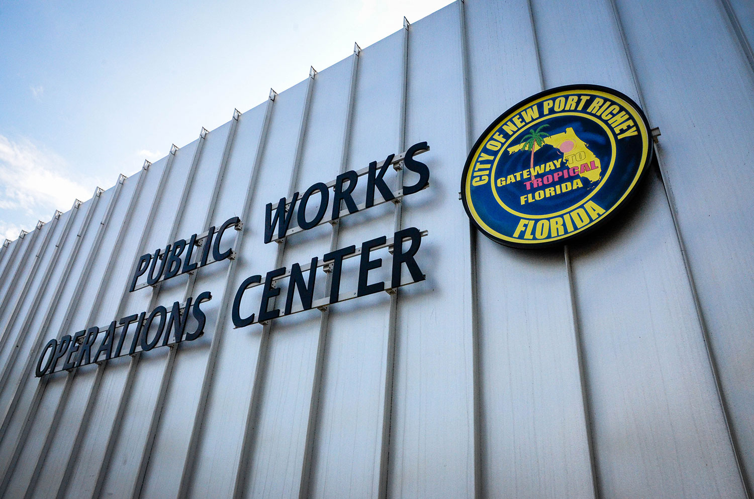 Building exterior, closeup of the words "Public Works Operations Center" next to the New Port Richey city seal.