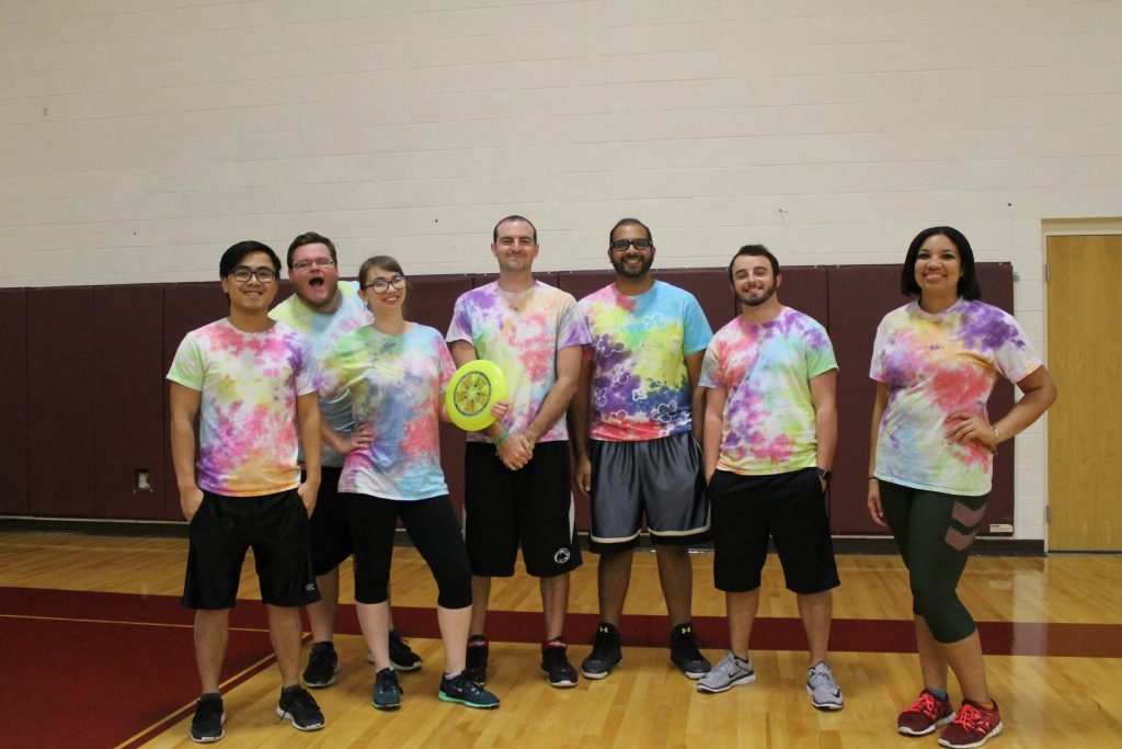 Group of seven ultimate frisbee players in tie-dye shirts