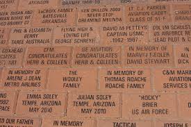 Brick wall or pavement with personal and family engravings.